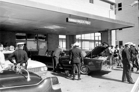 Police officers gather around the Presidential limousine in front of Parkland Hospital 01