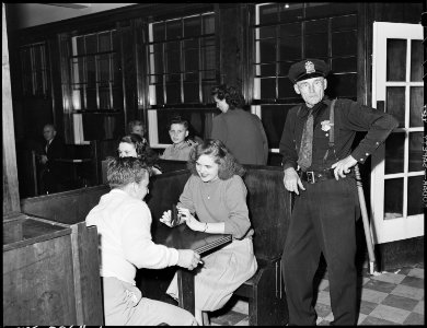 Policeman and couple in soda fountain prior to movie show. Inland Steel Company, Wheelwright ^1 & 2 Mines... - NARA - 541427