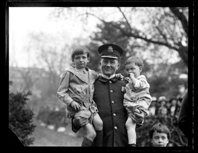 Police Officer holding children LCCN2016891361