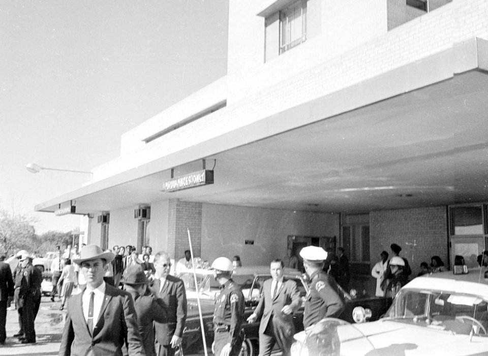 Police officers gather around the Presidential limousine in front of Parkland Hospital 03