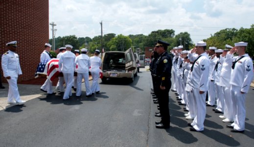 Police officers and Sailors render honors as the remains of Logistics Specialist 2nd Class Randall Smith are placed into a hearse. (19909353468) photo