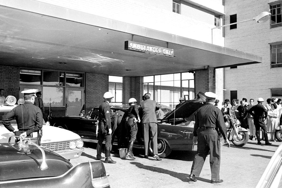 Police officers gather around the Presidential limousine in front of Parkland Hospital 04