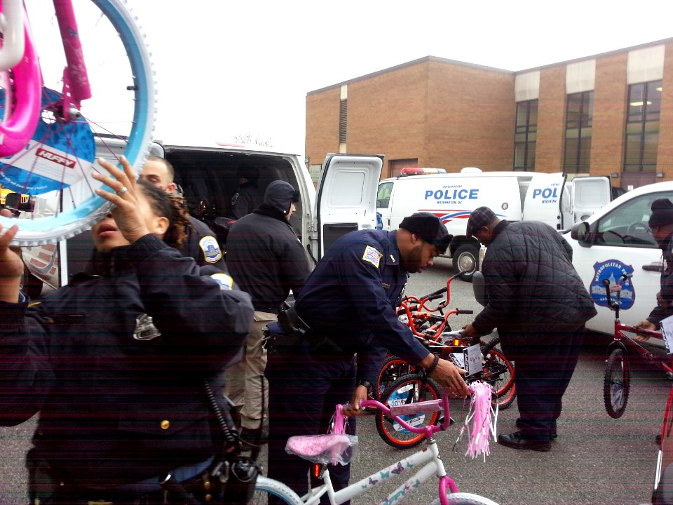 Police officers unload bicycles donated to the Toys for Tots program 131217-N-CG900-004