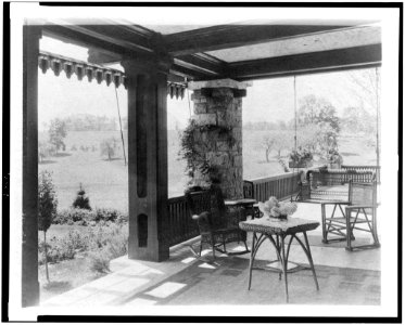 Porch with wicker furniture, and view over lawn to home of Edmund Cogswell Converse, Greenwich, Connecticut LCCN94502492