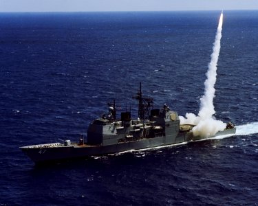 Port bow view of USS Ticonderoga (CG-47) firing Standard II missile in tests off Puerto Rico April 1983 DN-SC-84-10058