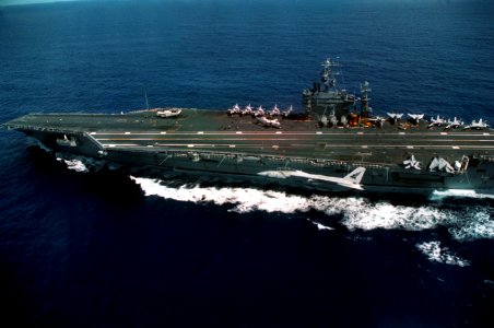 Port side view of USS George Washington (CVN-73) during shakedown with VF-143 F-14B Tomcat passing 1992 DN-SC-95-01451