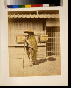 Porter wearing protective outer garments made of straw LCCN2009632872