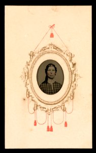 Portrait of a woman in a checkered dress, her image framed by gold and red decorative motif LCCN2016653258