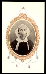 Portrait of a woman wearing head covering, her image framed by gold decorative motif LCCN2016653250