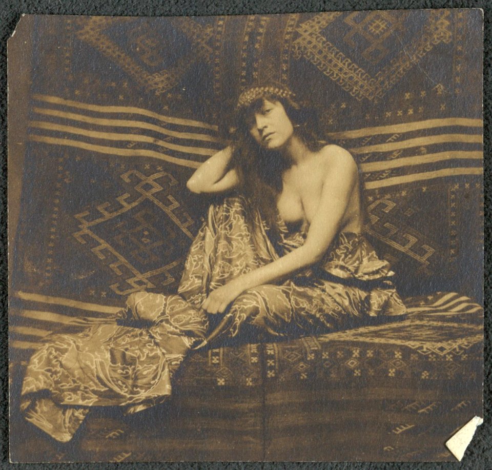 Portrait of a woman, partially draped, seated on a sofa LCCN2001697172