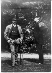 Portrait of artists William M. Chase and James M. Whistler, standing out doors, with top hats and canes LCCN2009630603