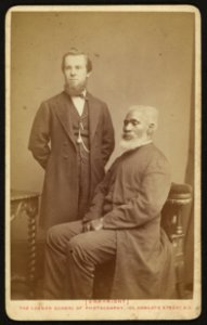 Portrait of Josiah Henson sitting next to an unidentified Caucasian man, both facing slightly left) - Bradshaw & Godart, successors to the London School of Photography, 103, Newgate Street, LCCN2010647932
