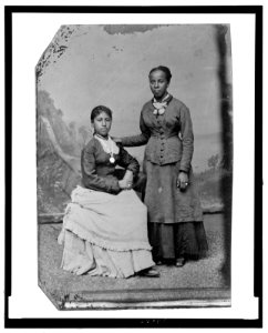 Portrait of two young African American women, one standing, one seated LCCN2006688040 photo