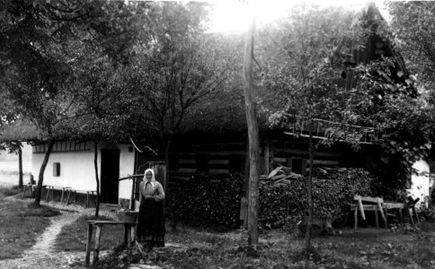 Portret Lenke Snoj, rojene Tomaž, pred hišo v Tacnu št. 45, 17. 7. 1927
