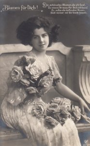 Postcard of a beautiful woman holding flowers