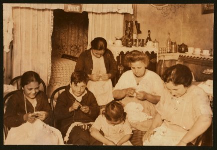 Powder puffs, 45 cents per gross. Family attempting to finish 9 gross in less than a week. Boy's hands were very dirty. LOC nclc.04323