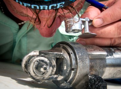 POW-MIA tecovery team member examines recovered wreckage 150524-N-IP743-242