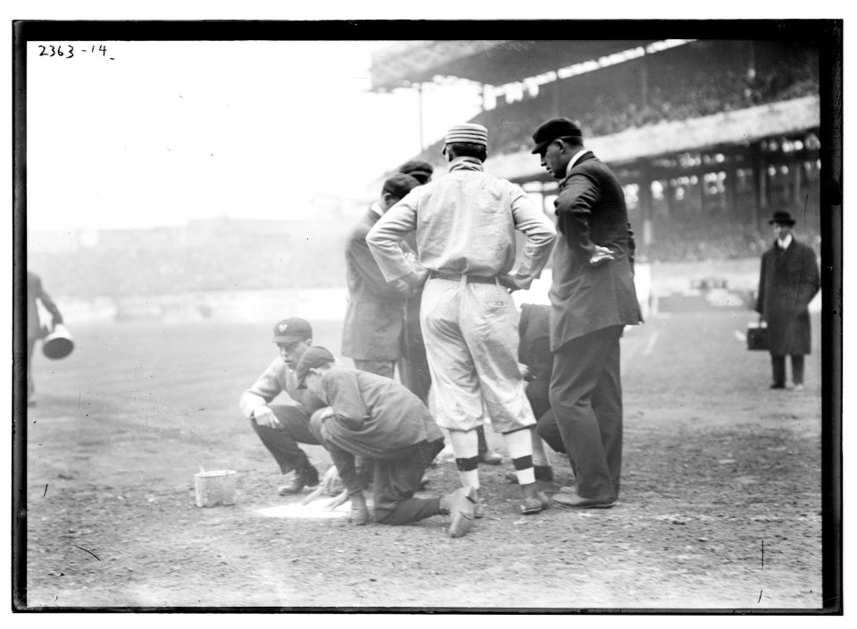 Pre-game activities at home plate involving managers, umpires, and grounds crew LCCN2014690095