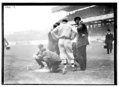 Pre-game activities at home plate involving managers, umpires, and grounds crew LCCN2014690095