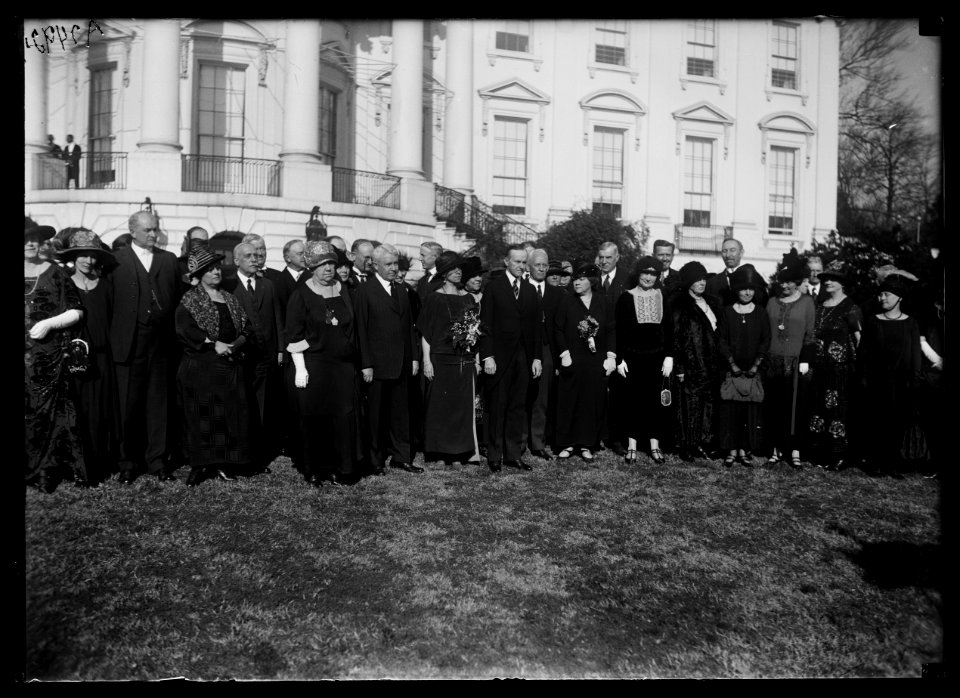 Pres. and Mrs. Coolidge entertain members of Rep. Nat'l Comm. at luncheon at White House, Dec. 12. Posed on south lawn LCCN2016887023