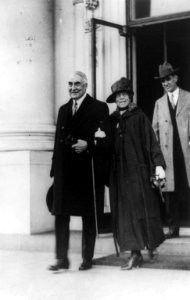 Pres. and Mrs. Harding, full-length portrait, walking arm-in-arm, followed by another man LCCN96513739