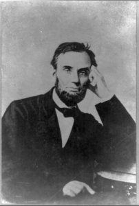 President Abraham Lincoln, seated, with his left hand on his face LCCN2013648773