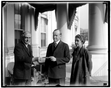 President and Mrs. Coolidge enrolled in American Red Cross by Judge John Barton Payne. The twelfth annual roll call of the American Red Cross was officially opened in Washington today when LCCN2016863105