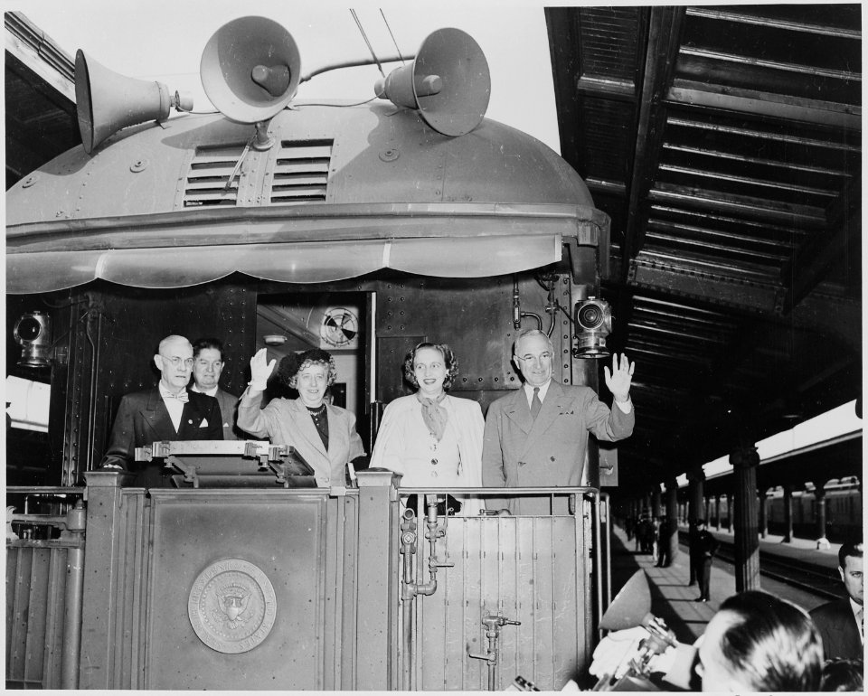 President and Mrs. Harry S. Truman, Margaret Truman, and two unidentified men standing on the rear platform of the... - NARA - 199961