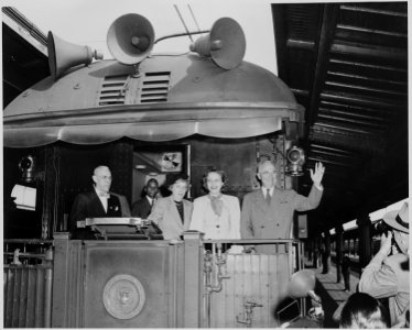 President and Mrs. Harry S. Truman, Margaret Truman, and an unidentified man standing on the rear platform of the... - NARA - 199963