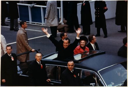 President and Mrs. Nixon waving to the crowd from the Presidential limousine in the Inaugural mototcade - NARA - 194282 photo