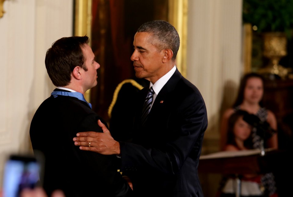 President Barack Obama congratulates Senior Chief Special Warfare Operator (SEAL) Edward C. Byers Jr. during a Medal of Honor presentation ceremony (25087910750)