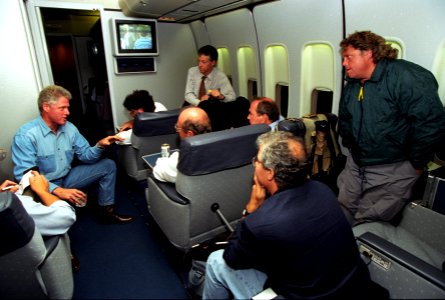 President Bill Clinton talks to reporters on Air Force One