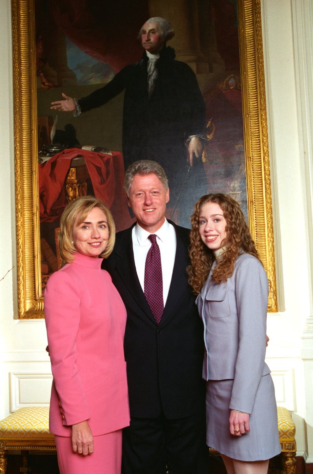 President Bill Clinton, First Lady Hillary Clinton, and daughter Chelsea Clinton pose for photographs in the East Room of the White House