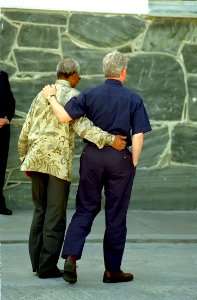 President Bill Clinton walks with President Nelson Mandela on Robben Island photo