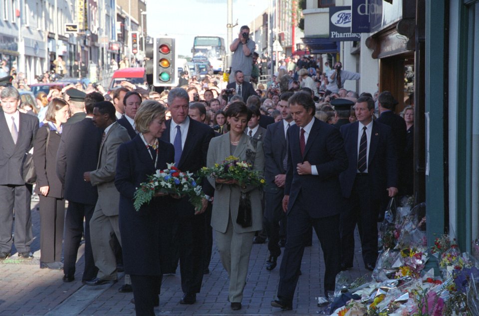 President Bill Clinton, First Lady Hillary Clinton, Prime Minister Tony Blair, and Cherie Blair bring flowers to the site of the Omagh bombing, on Market Street in Omagh, Northern Ireland