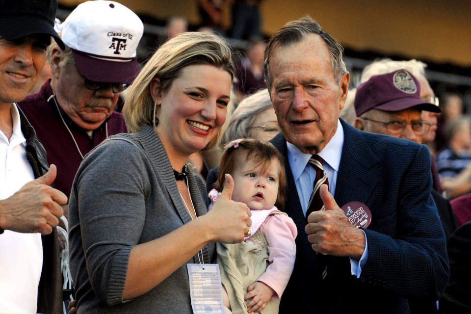 President George H. W. Bush gives the Texas A&M University Gig 'em sign