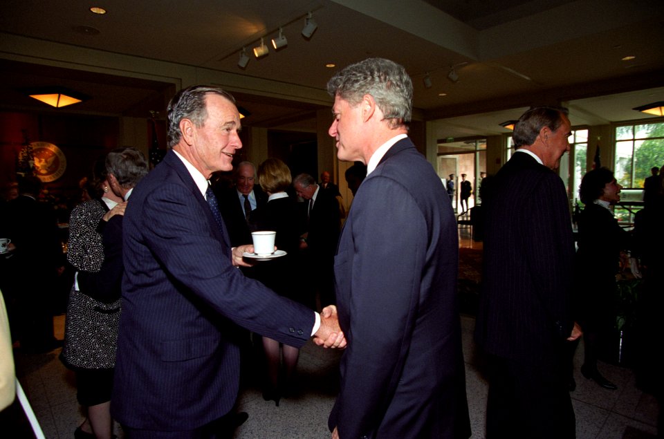 President George H. W. Bush shakes hands with President William J. Clinton