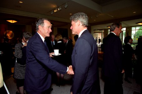President George H. W. Bush shakes hands with President William J. Clinton