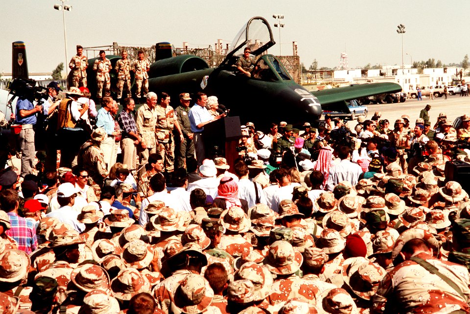 President George H. W. Bush speaks to a crowd at an air base in Saudi Arabia