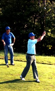 President George H. W. Bush golfing with George W. Bush