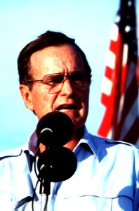 President George H. W. Bush speaks to the marines and sailors during a stop at a desert encampment
