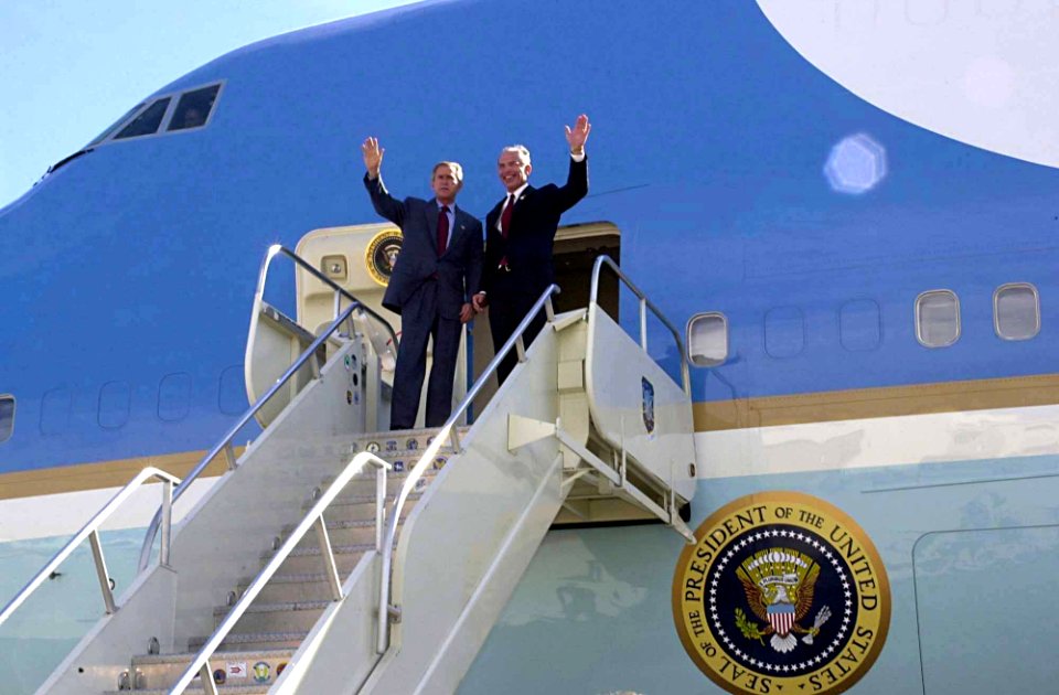 President George W. Bush and Representative Bob Beauprez wave for the top steps of Air Force One