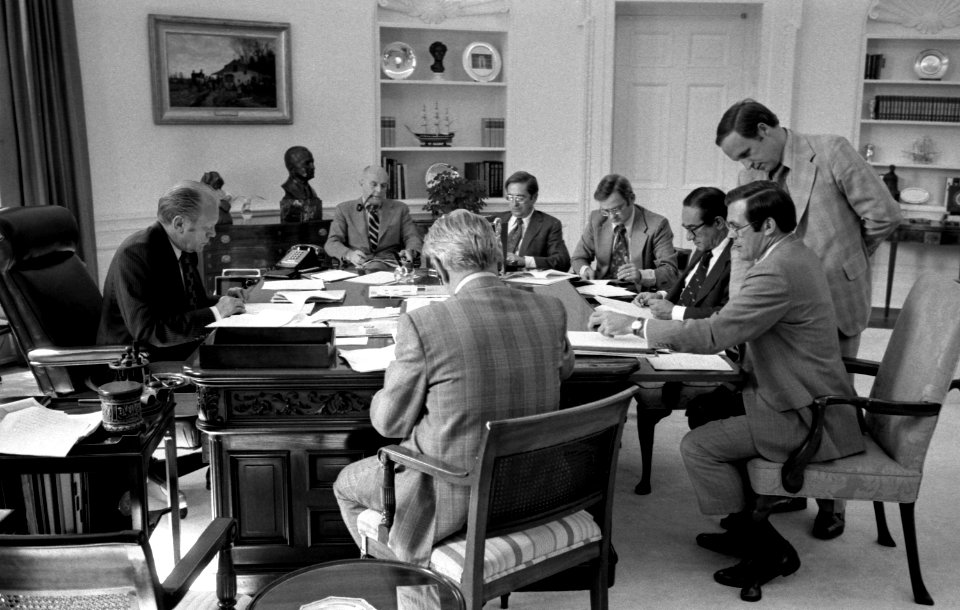 President Gerald Ford and staff review a draft of his address to the Nation on recommendations for tax reduction and spending