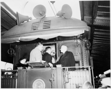 President Harry S. Truman on the rear platform of the presidential train, speaking to two unidentified men. Truman... - NARA - 199936