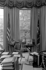 President Gerald Ford studies a speech during a meeting with his editorial staff