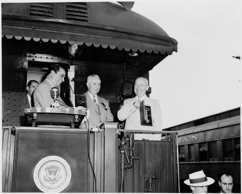 President Harry S. Truman, President Romulo Gallegos of Venezuela, and two unknown men standing on the rear platform... - NARA - 199891