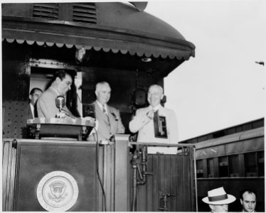 President Harry S. Truman, President Romulo Gallegos of Venezuela, and two unknown men standing on the rear platform... - NARA - 199891