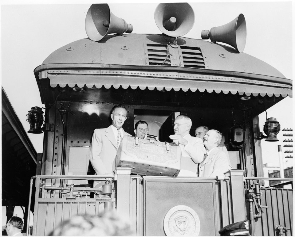 President Harry S. Truman and four unidentified men on the rear platform of the presidential train, probably in... - NARA - 199887