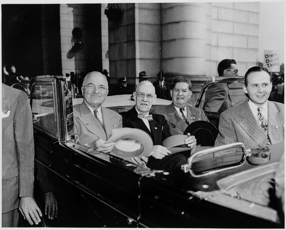 President Harry S. Truman and three unidentified men sitting in the back of an open car, probably in front of Union... - NARA - 199962