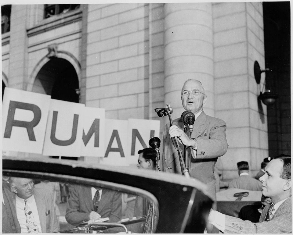 President Harry S. Truman standing in an open car, speaking into microphones, Washington, DC. President Truman had... - NARA - 199965